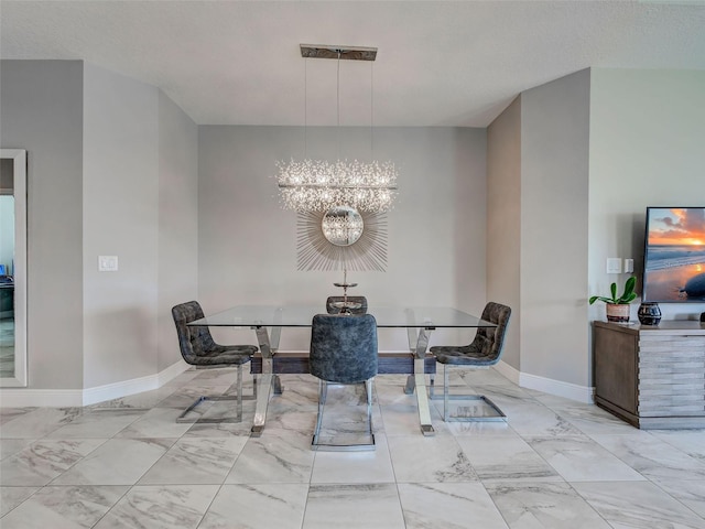 220 Sarezzo Cir, Nokomis, FL 34275 - dining room featuring marble finish flooring, a chandelier, and baseboards