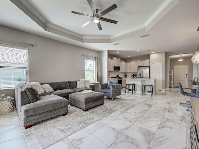 220 Sarezzo Cir, Nokomis, FL 34275 - living room with a raised ceiling, ornamental molding, a ceiling fan, and light marble finish floors
