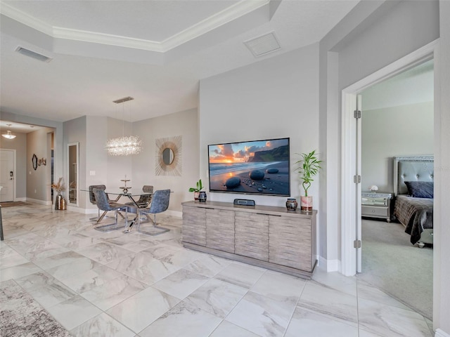 220 Sarezzo Cir, Nokomis, FL 34275 - living room featuring a tray ceiling, a chandelier, light marble finish floors, and ornamental molding