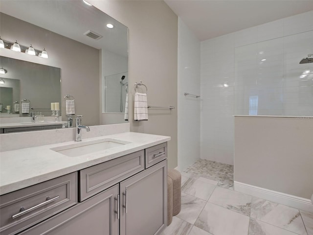 220 Sarezzo Cir, Nokomis, FL 34275 - bathroom featuring a walk in shower, vanity, and marble look tile flooring
