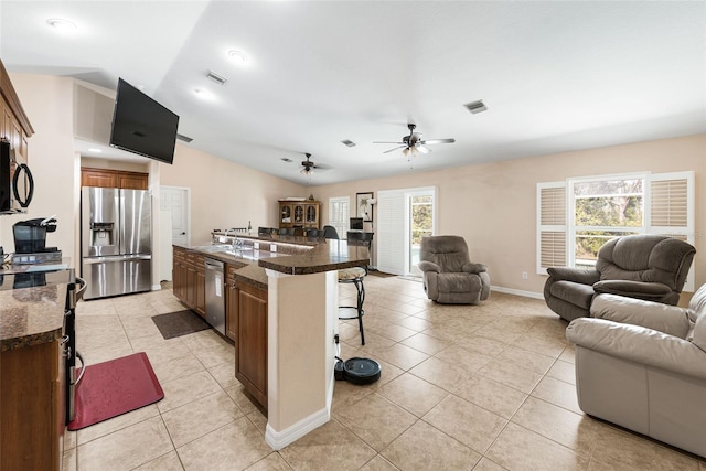 14124 Kewanee Ln, Port Charlotte, FL 33981 - kitchen featuring a kitchen breakfast bar, visible vents, stainless steel appliances, open floor plan, and vaulted ceiling