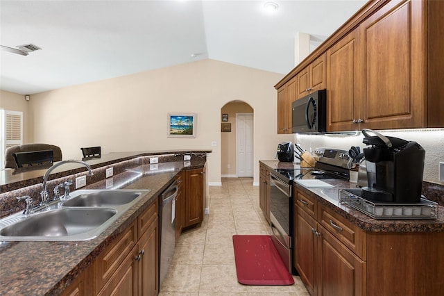 14124 Kewanee Ln, Port Charlotte, FL 33981 - kitchen with a sink, brown cabinets, stainless steel appliances, arched walkways, and lofted ceiling