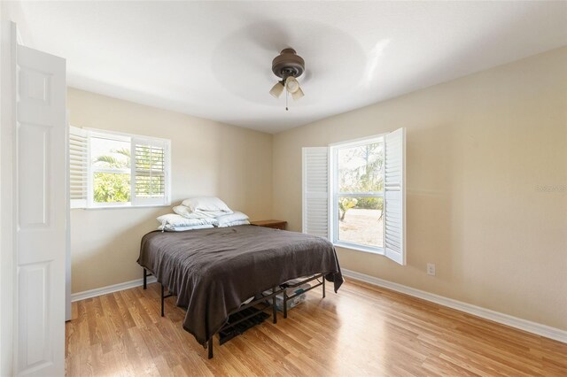 14124 Kewanee Ln, Port Charlotte, FL 33981 - bedroom featuring baseboards, a ceiling fan, and light wood-style flooring