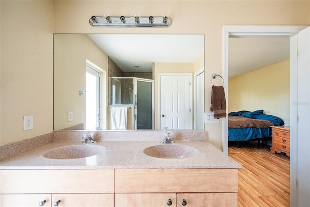 14124 Kewanee Ln, Port Charlotte, FL 33981 - bathroom with wood finished floors, a shower stall, double vanity, and a sink