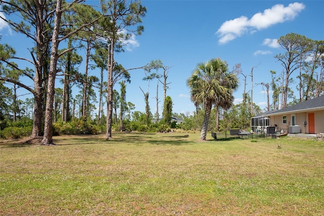 14124 Kewanee Ln, Port Charlotte, FL 33981 - view of yard featuring glass enclosure and central air condition unit