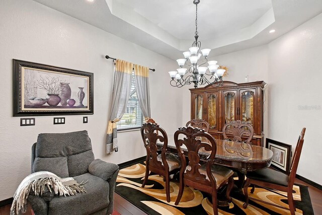 66 Statler St, Port Charlotte, FL 33954 - dining room featuring a chandelier, recessed lighting, baseboards, wood finished floors, and a tray ceiling