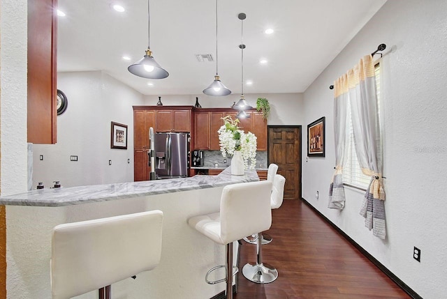 66 Statler St, Port Charlotte, FL 33954 - kitchen with stainless steel fridge, recessed lighting, a kitchen bar, backsplash, and visible vents