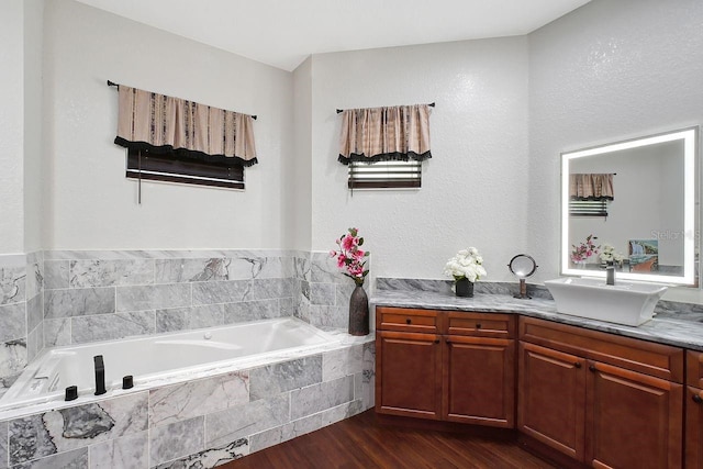 66 Statler St, Port Charlotte, FL 33954 - full bath with a bath, vanity, a textured wall, and wood finished floors