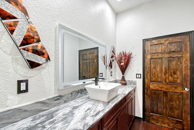66 Statler St, Port Charlotte, FL 33954 - bathroom with vanity, a textured wall, and wood finished floors