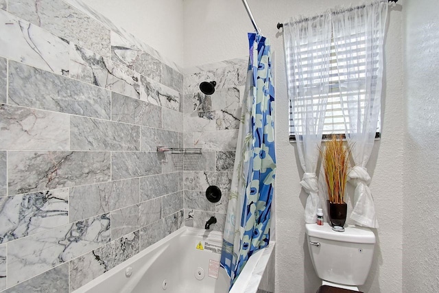 66 Statler St, Port Charlotte, FL 33954 - full bathroom featuring a textured wall, toilet, and a combined bath / shower with jetted tub