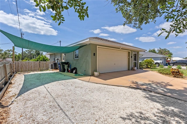 5264 Albion Rd, Venice, FL 34293 - view of home's exterior with stucco siding, fence, a garage, central AC unit, and driveway