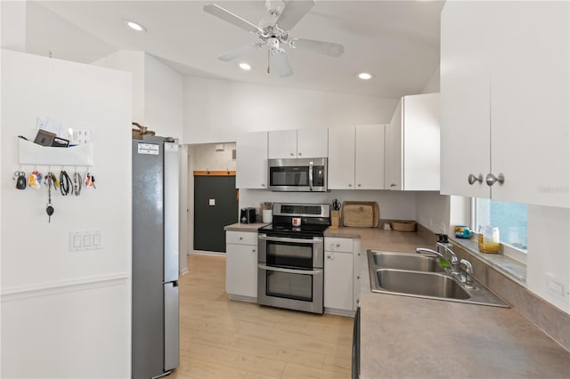 5264 Albion Rd, Venice, FL 34293 - kitchen with white cabinets, light wood-style flooring, a sink, appliances with stainless steel finishes, and ceiling fan