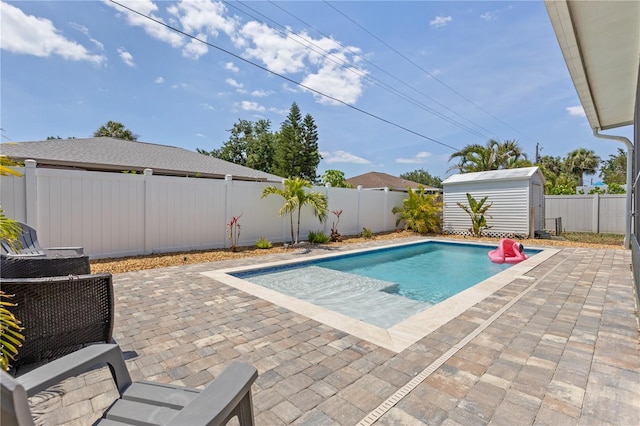 5264 Albion Rd, Venice, FL 34293 - view of pool featuring a patio area, an outbuilding, a fenced in pool, a fenced backyard, and a shed