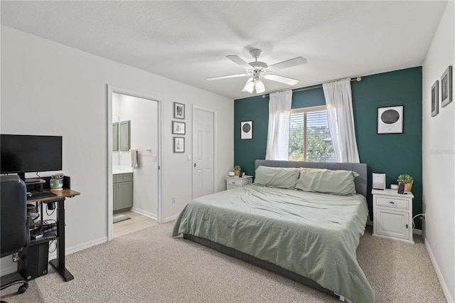 5264 Albion Rd, Venice, FL 34293 - bedroom with ensuite bath, light carpet, and baseboards