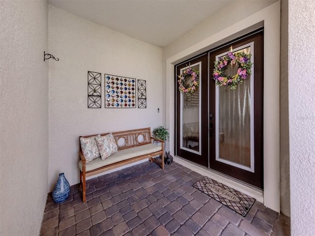 property entrance with stucco siding