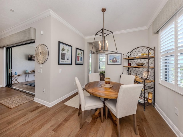 dining space featuring plenty of natural light, baseboards, a chandelier, and light wood-type flooring