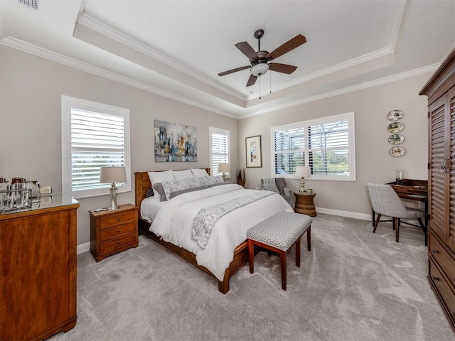 bedroom with crown molding, light carpet, a raised ceiling, and baseboards