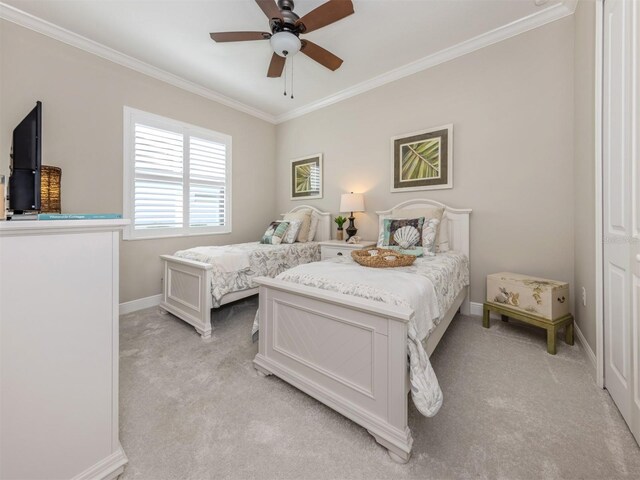bedroom featuring crown molding, ceiling fan, light colored carpet, and baseboards