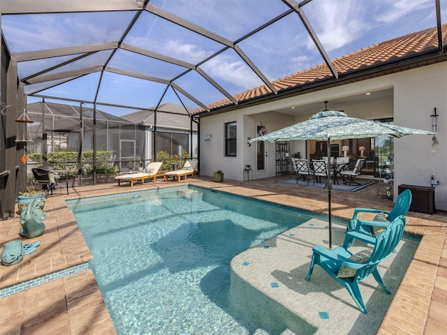 pool with a lanai, outdoor dining space, and a patio area