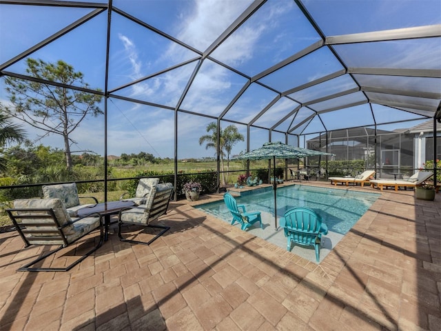 pool with a lanai and a patio area