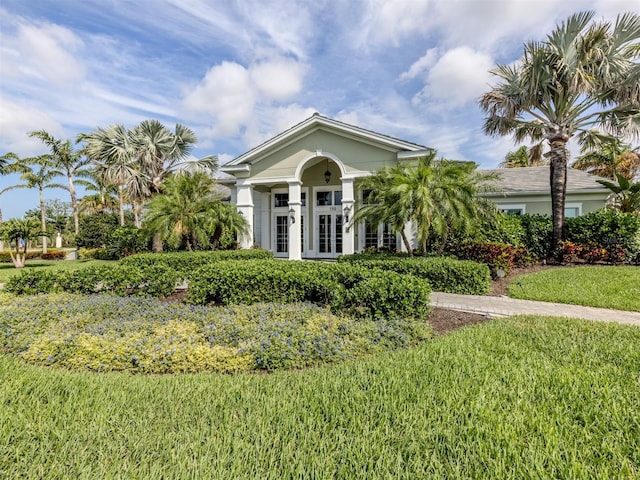 view of front facade with french doors and a front yard