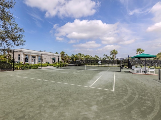 view of tennis court featuring fence