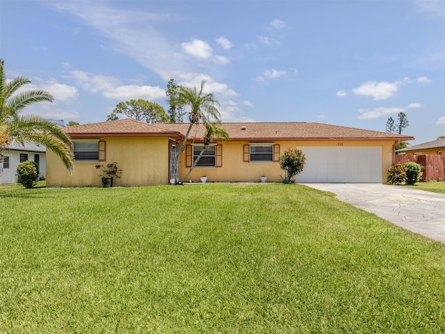 ranch-style house featuring driveway, stucco siding, a front yard, fence, and a garage