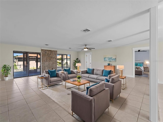 living area with light tile patterned floors, ceiling fan, and visible vents