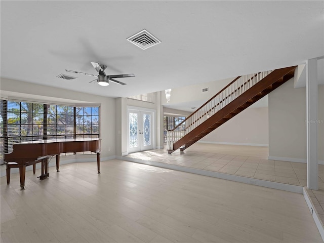 interior space featuring visible vents, wood finished floors, and stairway