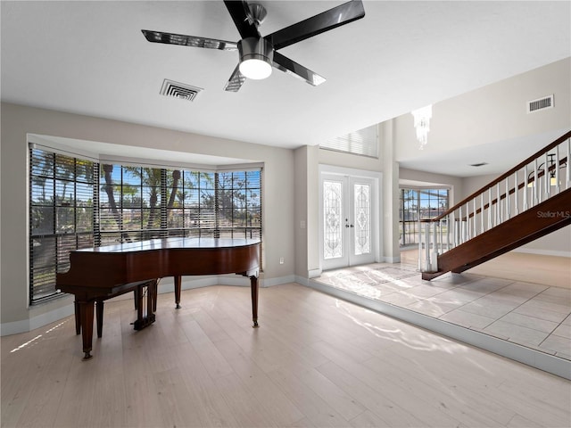 entrance foyer with visible vents, wood finished floors, and baseboards