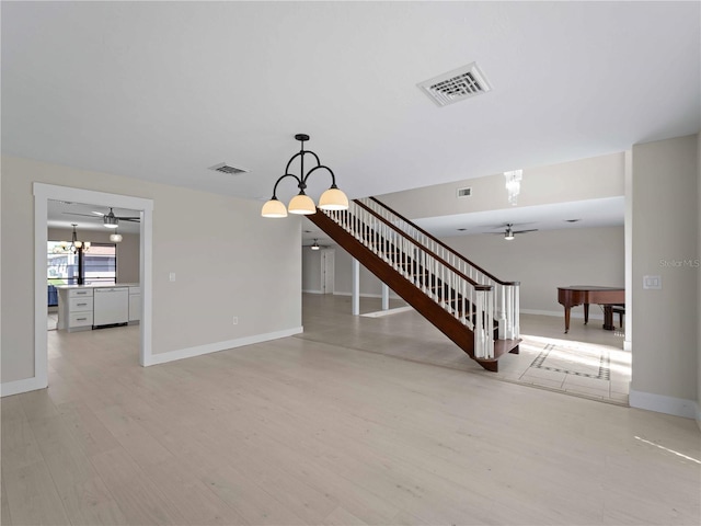 unfurnished living room with visible vents, a ceiling fan, and light wood-style floors
