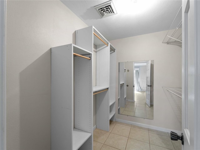 spacious closet with light tile patterned floors and visible vents