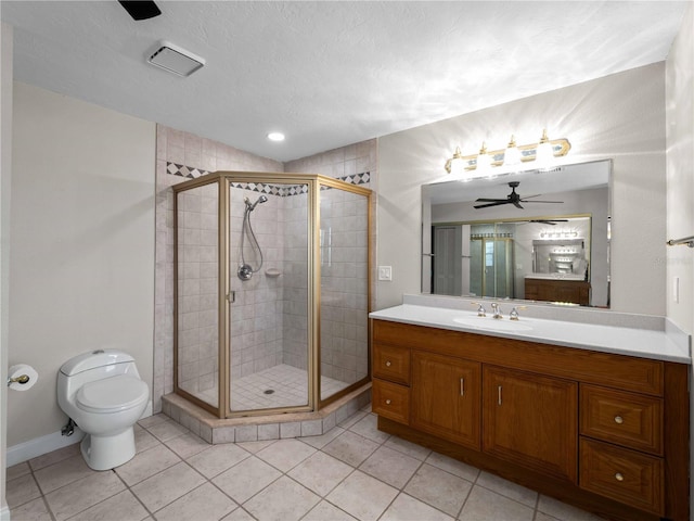 bathroom with toilet, a stall shower, ceiling fan, and vanity