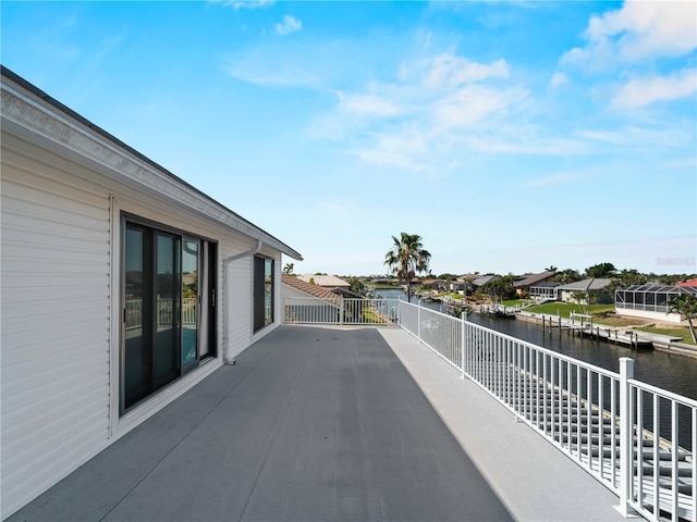 exterior space with a water view, a residential view, and a balcony