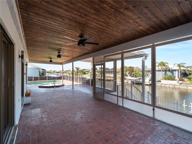 view of patio / terrace featuring a ceiling fan and a water view