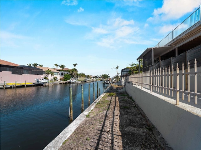 view of dock featuring a water view and a residential view