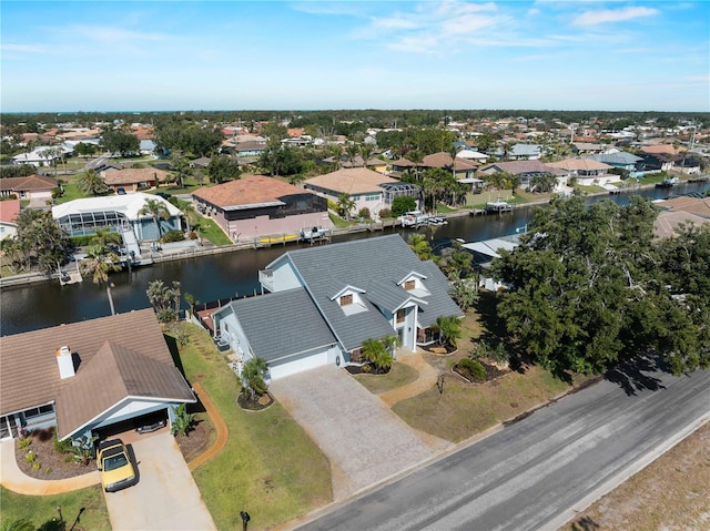 drone / aerial view with a residential view and a water view