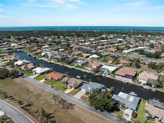 drone / aerial view with a residential view and a water view