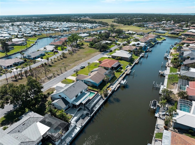 birds eye view of property with a residential view and a water view