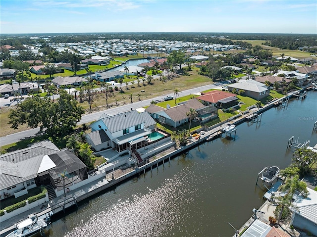 drone / aerial view with a residential view and a water view