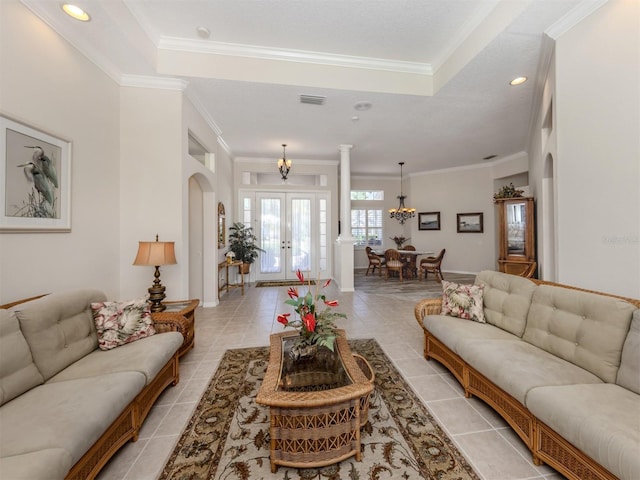 2022 Calusa Lakes Blvd, Nokomis, FL 34275 - living room with a chandelier, light tile patterned floors, visible vents, ornamental molding, and arched walkways