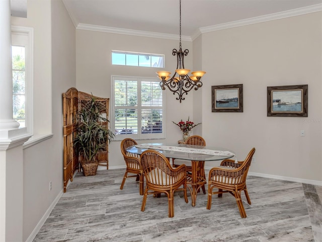 2022 Calusa Lakes Blvd, Nokomis, FL 34275 - dining space with crown molding, an inviting chandelier, baseboards, and light wood-type flooring