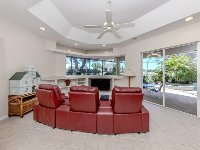 2022 Calusa Lakes Blvd, Nokomis, FL 34275 - home theater with light tile patterned flooring, recessed lighting, a ceiling fan, and a raised ceiling