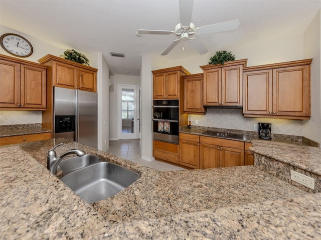 2022 Calusa Lakes Blvd, Nokomis, FL 34275 - kitchen featuring black appliances, a sink, brown cabinetry, and visible vents