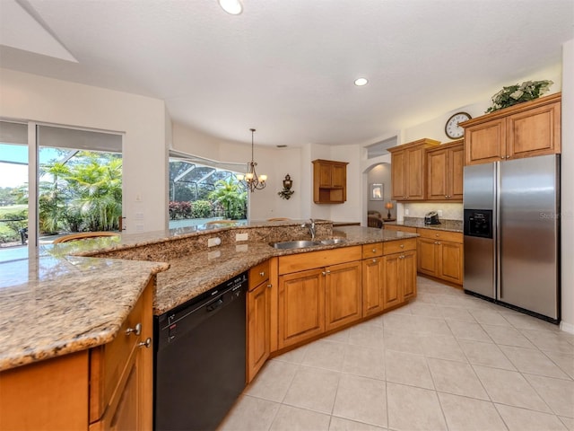 2022 Calusa Lakes Blvd, Nokomis, FL 34275 - kitchen with a sink, brown cabinets, light tile patterned flooring, stainless steel refrigerator with ice dispenser, and dishwasher