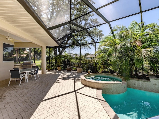 2022 Calusa Lakes Blvd, Nokomis, FL 34275 - view of patio with a pool with connected hot tub, ceiling fan, a grill, exterior kitchen, and a lanai