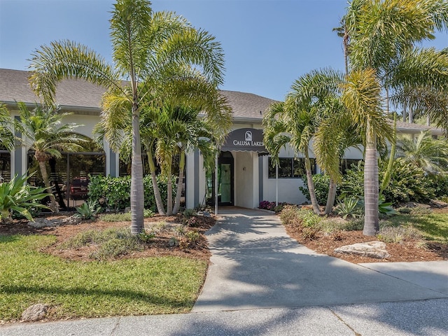 2022 Calusa Lakes Blvd, Nokomis, FL 34275 - view of front of house featuring a carport, a shingled roof, and concrete driveway