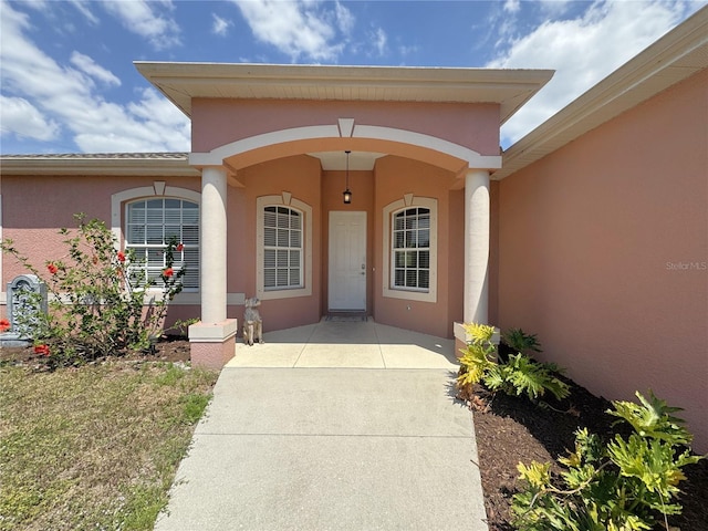 entrance to property with stucco siding