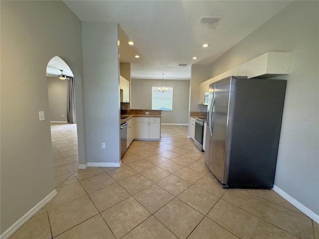 kitchen with appliances with stainless steel finishes, light tile patterned floors, recessed lighting, and white cabinets
