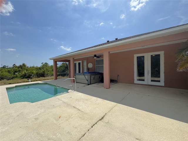 pool with a patio, french doors, ceiling fan, and a hot tub